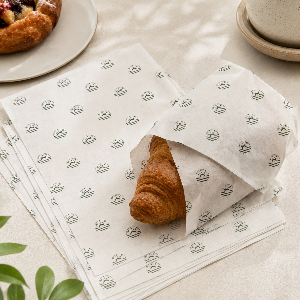 Bakery tissue sheets, custom-printed greaseproof paper with sunburst logo stamp