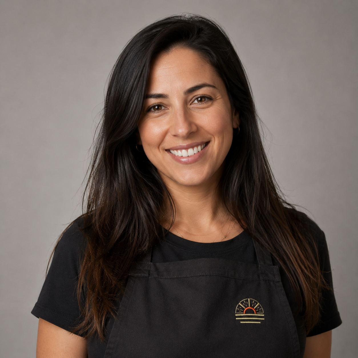 Ofek Arush, Co-Founder and CEO, professional headshot wearing an apron with the sunburst logo